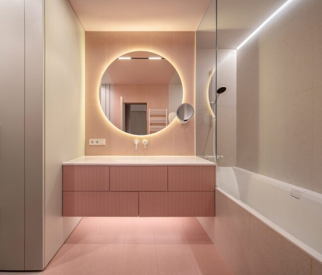 Modern Pink Vanity Complemented by a Circular Mirror