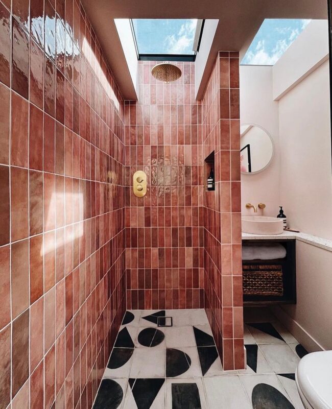 Sunlit Pink-Tiled Shower with Skylight Above