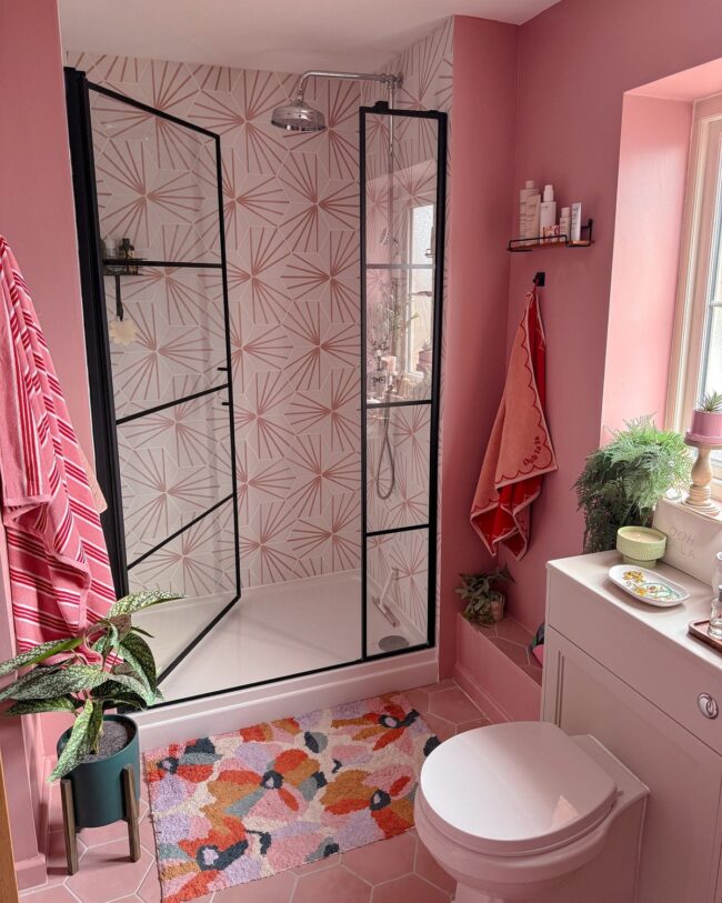 Pink Graphic Tiles with Black Trim in the Shower