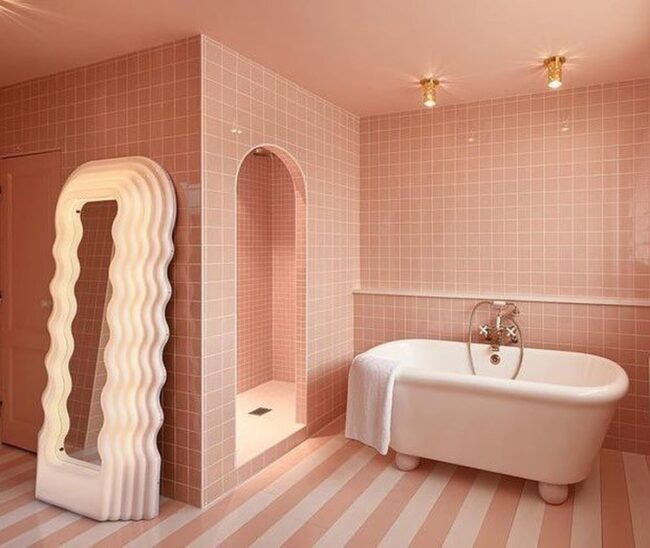 Playful Pink Tiles with a Freestanding Tub